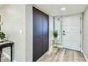 Bright entryway with dark wood closet doors and wood-look floors at 7520 N Via De Manana --, Scottsdale, AZ 85258