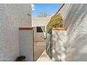 Private courtyard access with wrought iron gate at 7636 E Medlock Dr, Scottsdale, AZ 85250