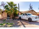 House exterior with a driveway and palm trees at 8717 W Wilshire Dr, Phoenix, AZ 85037