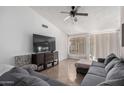 Spacious living room featuring a sectional sofa and large TV at 8717 W Wilshire Dr, Phoenix, AZ 85037