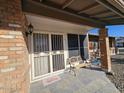 Covered porch with tile flooring, security door, and bench at 8803 N 105Th Ln, Peoria, AZ 85345