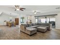 Open-concept living space featuring a sectional sofa and wood-look floors at 8856 E Altadena Ave, Scottsdale, AZ 85260
