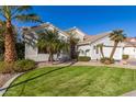 Single-story home with a two-car garage, palm trees, and a lush green lawn at 962 S Jacob St, Gilbert, AZ 85296