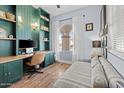 Bright home office featuring custom green built-ins and hardwood floors at 10713 E Hawk Ave, Mesa, AZ 85212