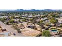 Aerial view showing property, surrounding homes, and mountain views at 10810 N 82Nd Pl, Scottsdale, AZ 85260