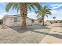 Side view of a ranch-style home showcasing its brick exterior and landscaping at 12435 W Galaxy Dr, Sun City West, AZ 85375