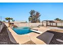 Inviting backyard pool with waterfall feature and diving board at 12660 N 42Nd Dr, Phoenix, AZ 85029