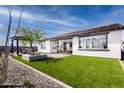 Spacious backyard with artificial turf, a pergola, and patio at 1304 W Golden Ore Pass, Apache Junction, AZ 85120