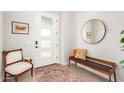 Entryway with a bench, mirror, and antique chair at 15320 W Baden St, Goodyear, AZ 85338