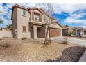Two-story house with a brown garage door and desert landscaping at 16958 W Marconi Ave, Surprise, AZ 85388