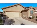 Tan house with two-car garage, welcoming bench, and landscaped yard at 18350 W Via Del Sol --, Surprise, AZ 85387