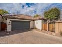 Attached garage with paver driveway and wooden gate at 2472 E Vermont Dr, Gilbert, AZ 85295