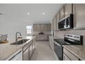 Modern kitchen features stainless steel appliances and granite countertops at 2937 E Lawndale Ct, Gilbert, AZ 85298
