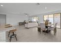 Open living space with a ceiling fan, tile flooring, and access to the outdoor patio at 2937 E Lawndale Ct, Gilbert, AZ 85298