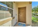 Front entrance with brown door and welcoming doormat at 29460 N 123Rd Gln, Peoria, AZ 85383