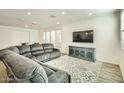Spacious living room with sectional sofa and large TV at 29460 N 123Rd Gln, Peoria, AZ 85383