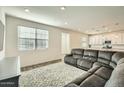 Open floor plan living room with kitchen view at 29460 N 123Rd Gln, Peoria, AZ 85383