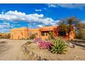 Orange stucco home with mature desert landscaping at 31825 N 141St St, Scottsdale, AZ 85262