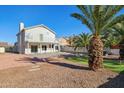 Two-story house with a backyard pool, putting green, and mature palm trees at 3212 N 109Th Ave, Avondale, AZ 85392