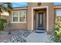 Front entry with decorative wrought iron door and stone accents at 42585 W Heavenly Pl, Maricopa, AZ 85138