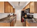Modern kitchen with granite countertops and wood cabinets at 5877 N Granite Reef Rd # 2212, Scottsdale, AZ 85250