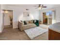 Living room features a beige sofa and access to a private balcony at 5877 N Granite Reef Rd # 2212, Scottsdale, AZ 85250