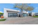 Two modern homes with attached garages and manicured lawns at 6826 E Joshua Tree Ln, Paradise Valley, AZ 85253