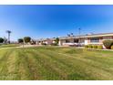 View of a row of homes showcasing a neat and spacious yard at 9459 N 111Th Ave, Sun City, AZ 85351