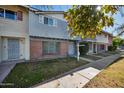 Row of townhouses showcasing a light gray facade and landscaping at 1307 N 44Th St, Phoenix, AZ 85008