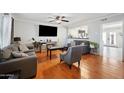 Bright living room with hardwood floors, comfortable seating, and a view into the kitchen at 1307 N 44Th St, Phoenix, AZ 85008