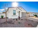 One-story home with gray garage door and drought-tolerant landscaping at 17765 W Silverwood Dr, Goodyear, AZ 85338