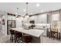 Modern kitchen with white cabinets, stainless steel appliances, and an island at 17765 W Silverwood Dr, Goodyear, AZ 85338