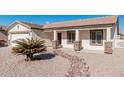 Front view of a single-story house with stone accents and a palm tree at 2101 S Meridian Rd # 268, Apache Junction, AZ 85120