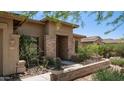 Inviting front entrance with stone accents, desert landscaping, and views of the neighborhood at 4119 S Las Villa Way, Gold Canyon, AZ 85118