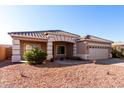 One-story home with tan exterior, tile roof, and attached garage at 4233 E Colonial Dr, Chandler, AZ 85249