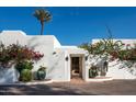Elegant entryway with ornate wooden doors and vibrant bougainvillea at 6617 N Central Ave, Phoenix, AZ 85012