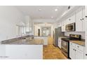 Spacious kitchen with granite countertops and white cabinetry at 8653 E Royal Palm Rd # 2014, Scottsdale, AZ 85258