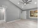 Bright living room with vaulted ceiling and new flooring at 8908 W Loma Ln, Peoria, AZ 85345