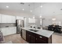 Modern kitchen with island, stainless steel appliances, and white cabinets at 8938 N 15Th Ln, Phoenix, AZ 85021