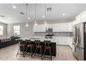 Modern kitchen with a large island, stainless steel appliances, and white cabinets at 8938 N 15Th Ln, Phoenix, AZ 85021