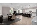 Open concept kitchen with island, stainless steel appliances, and white cabinets at 8938 N 15Th Ln, Phoenix, AZ 85021