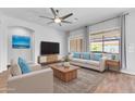 Comfortable living room features a sofa, armchairs, modern TV, and stylish decor at 10141 E Stealth Ave, Mesa, AZ 85212