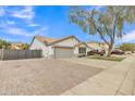 House exterior showcasing a driveway, landscaping, and a two-car garage at 10618 W Villa Chula Dr, Peoria, AZ 85383