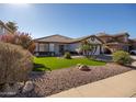 Single-story home with landscaped front yard, artificial turf, and desert landscaping at 10873 W Carlota Ln, Peoria, AZ 85373