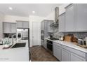 Modern kitchen with gray cabinets, white countertops, and stainless steel appliances at 19231 W Missouri Ave, Litchfield Park, AZ 85340