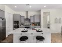 Modern kitchen with gray cabinets, island, and stainless steel appliances at 19231 W Missouri Ave, Litchfield Park, AZ 85340