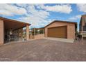 Outdoor kitchen and patio area with a built-in grill and seating at 2419 S 200Th Ln, Buckeye, AZ 85326