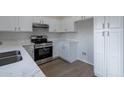 Stainless steel appliances and white cabinetry in this updated kitchen at 3555 S Moccasin Trl, Gilbert, AZ 85297