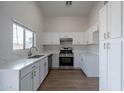 Modern kitchen featuring white cabinets and quartz countertops at 3555 S Moccasin Trl, Gilbert, AZ 85297