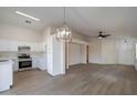 Open concept kitchen with modern appliances and light wood flooring at 3555 S Moccasin Trl, Gilbert, AZ 85297